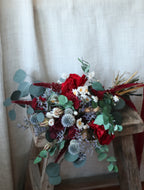 Bouquet of red and green flowers on a textured surface
